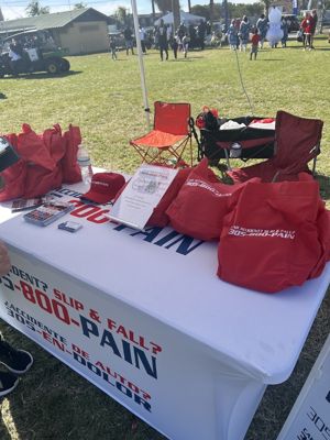 305-800-PAIN event booth with branded swag, Miami FL
